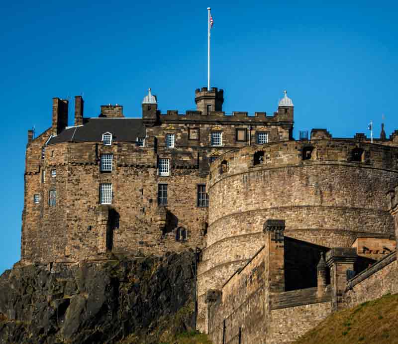 Stone fortification perched high on hillside.