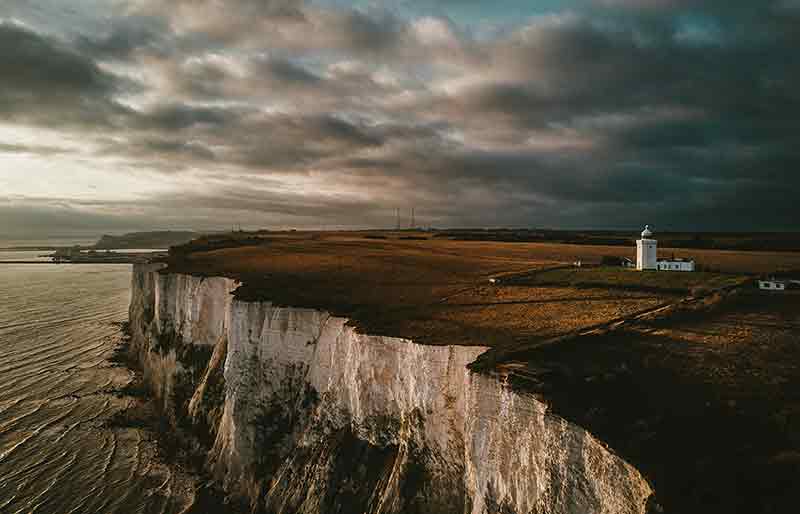 The White Cliffs and sea under a dramatic dark sky.