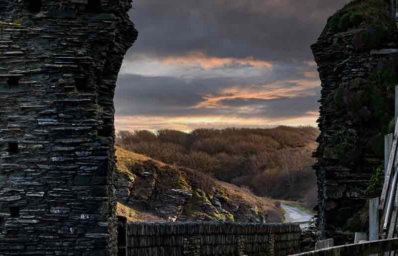 Through a stone-built arch out onto the rocks.